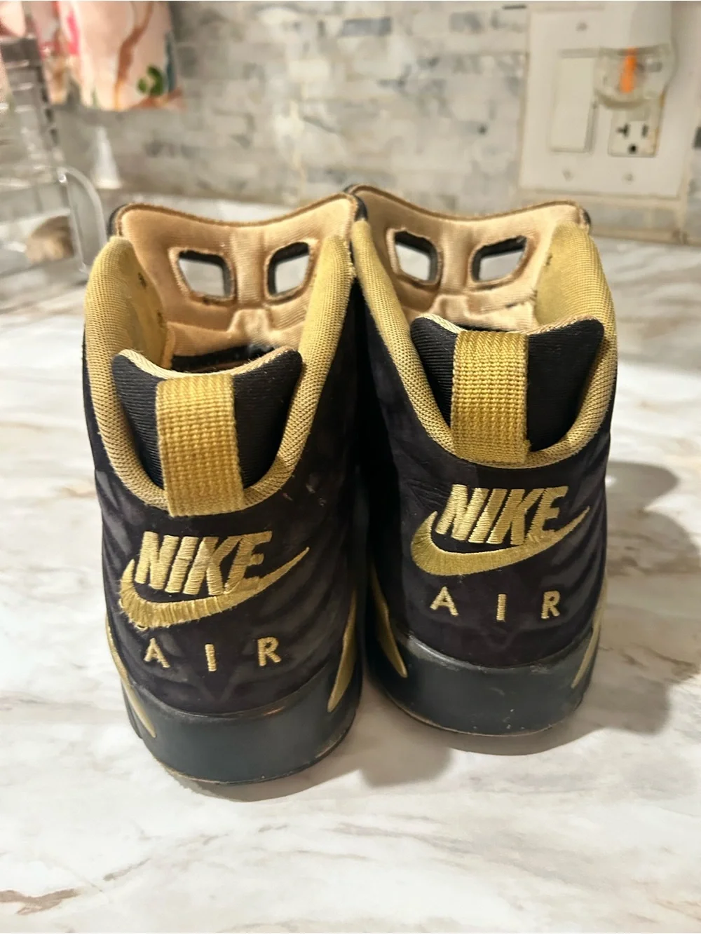 Jordan Black and Metallic Gold High-Top Sneakers